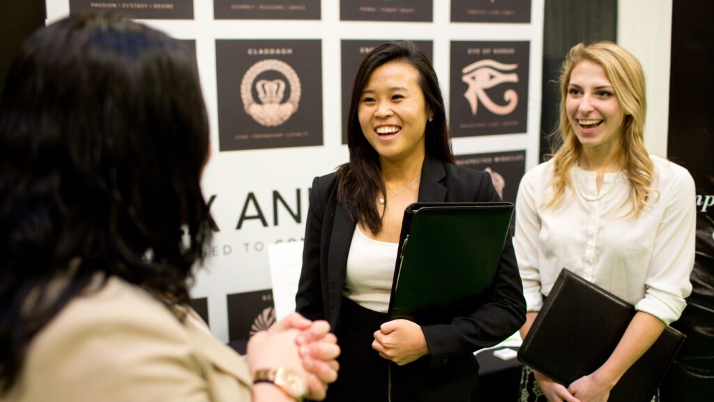 students talking to an employer at career fair
