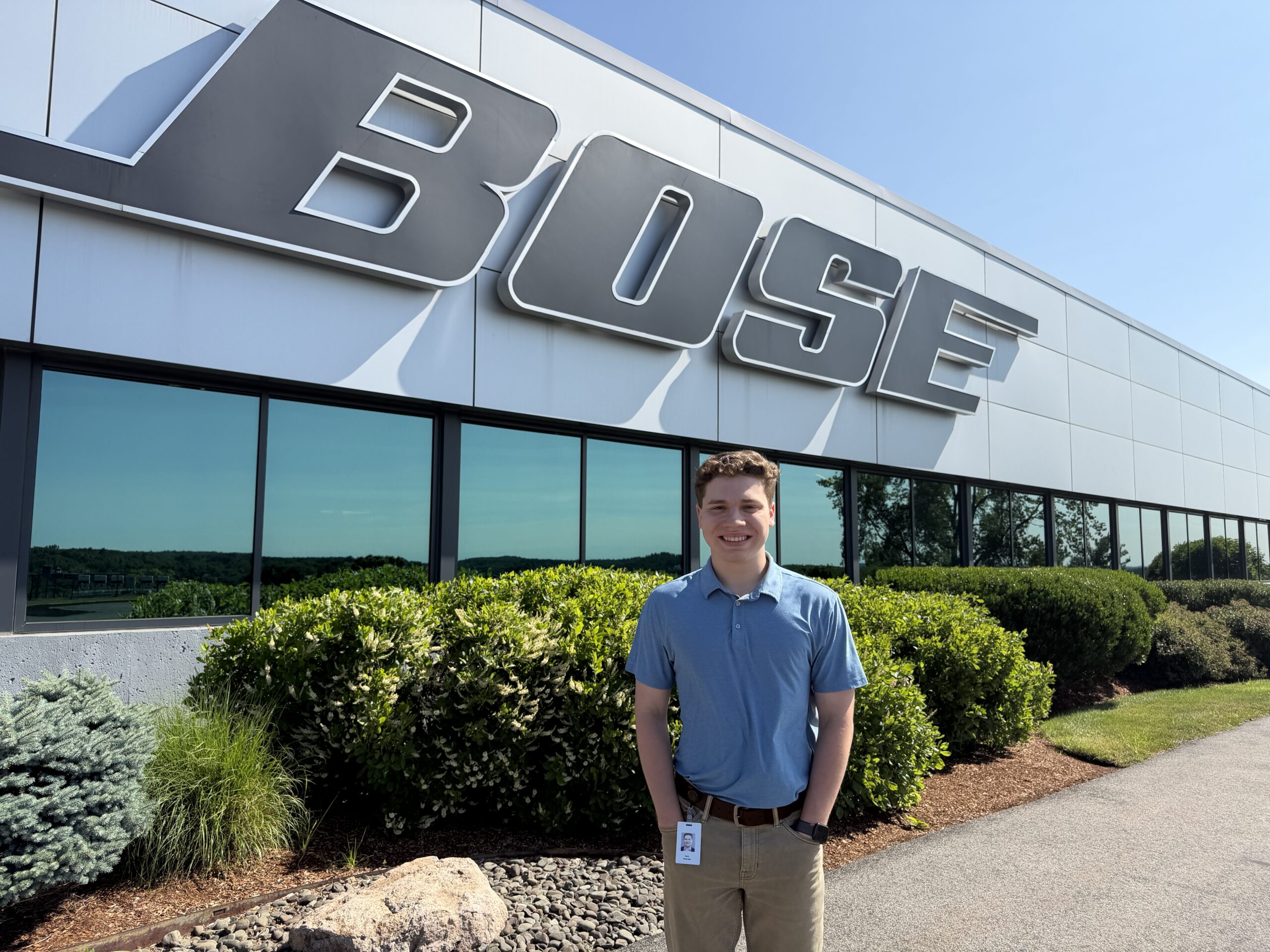 student at internship in front of BOSE office